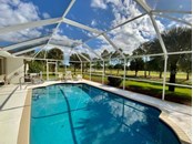 Caged Pool Area and Backyard View - Single Family Home for sale at 11 Long Meadow Rd, Rotonda West, FL 33947 - MLS Number is D6121957