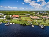 Parcel #4 is shown in the private subdivision of Lea Marie Island, looking across the East Spring Waterway. All overhead drone pictures are from July, 2018. - Vacant Land for sale at 4030 Lea Marie Island Dr, Port Charlotte, FL 33952 - MLS Number is C7404124