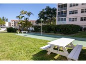 Shuffleboard and two BBQ grills can also be found in the courtyard - Condo for sale at 244 Saint Augustine Ave #104, Venice, FL 34285 - MLS Number is A4518081