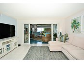 Living room with through the lanai bay views - Condo for sale at 450 Gulf Of Mexico Dr #B107, Longboat Key, FL 34228 - MLS Number is A4520786