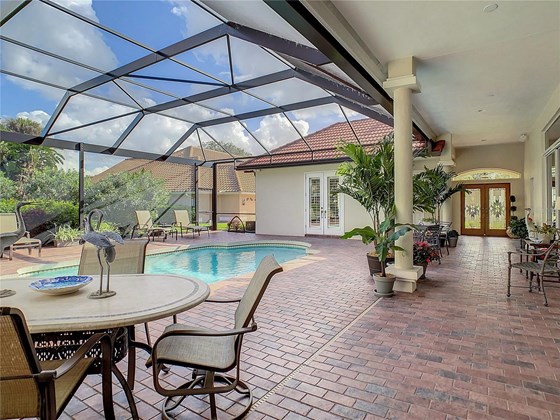 Oversized lanai in this courtyard has travertine pavers....awesome! - Single Family Home for sale at 319 Stone Briar Creek Dr, Venice, FL 34292 - MLS Number is A4522164