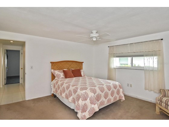 Master bedroom. Hallway to bedroom 2 - Single Family Home for sale at 19 Oakwood Dr N #19, Englewood, FL 34223 - MLS Number is N6118266